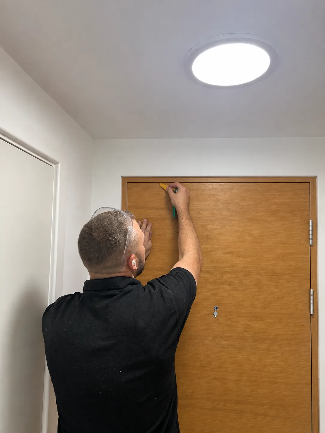 Vanguard engineer fitting a new fire door